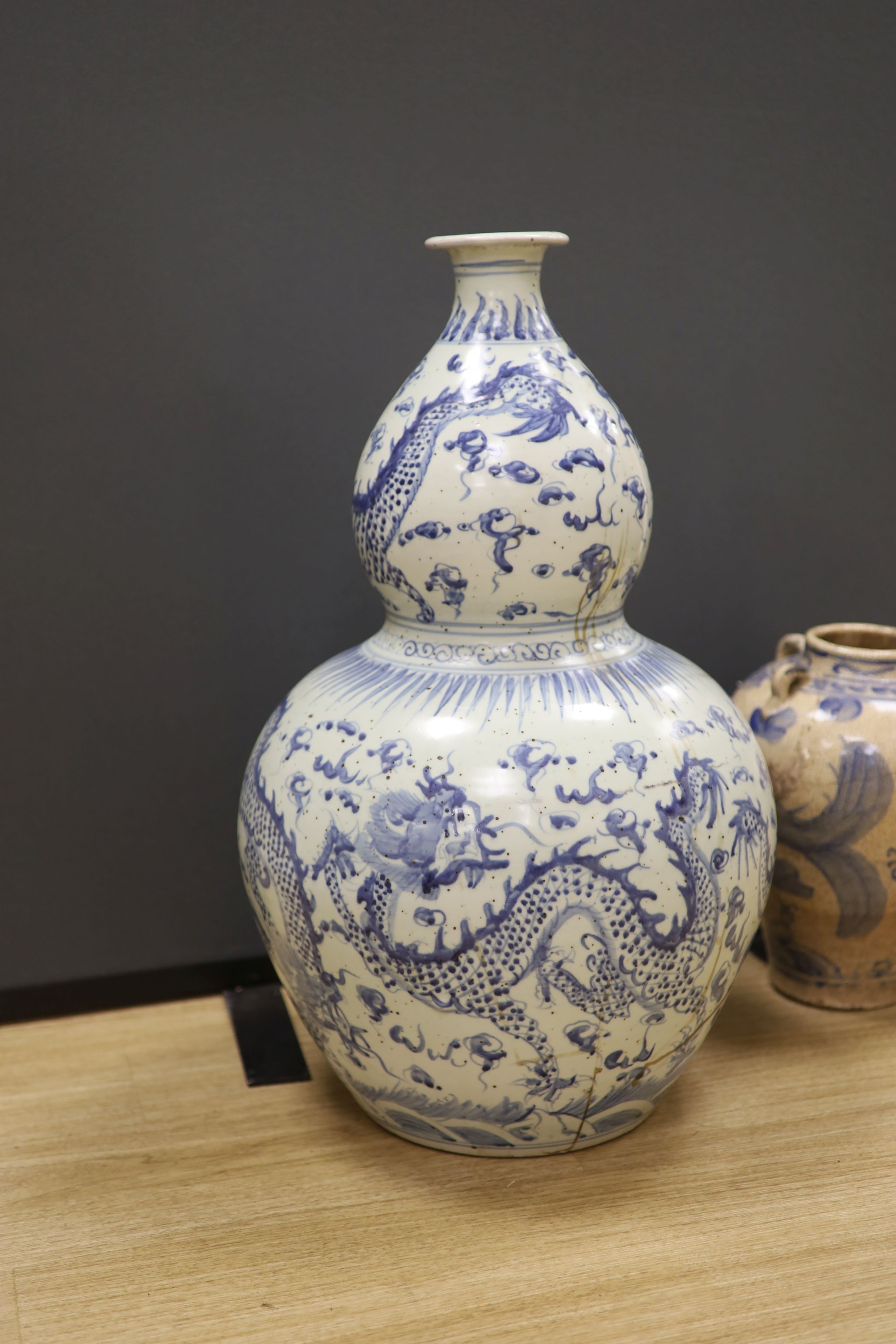 A large Chinese blue and white ‘dragon’ double gourd vase, 64cm high and an Annamese style blue and white crackle glaze jar